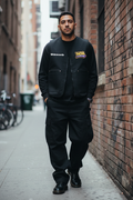 Hispanic male in Doc Martens wearing black Wckrecords vest